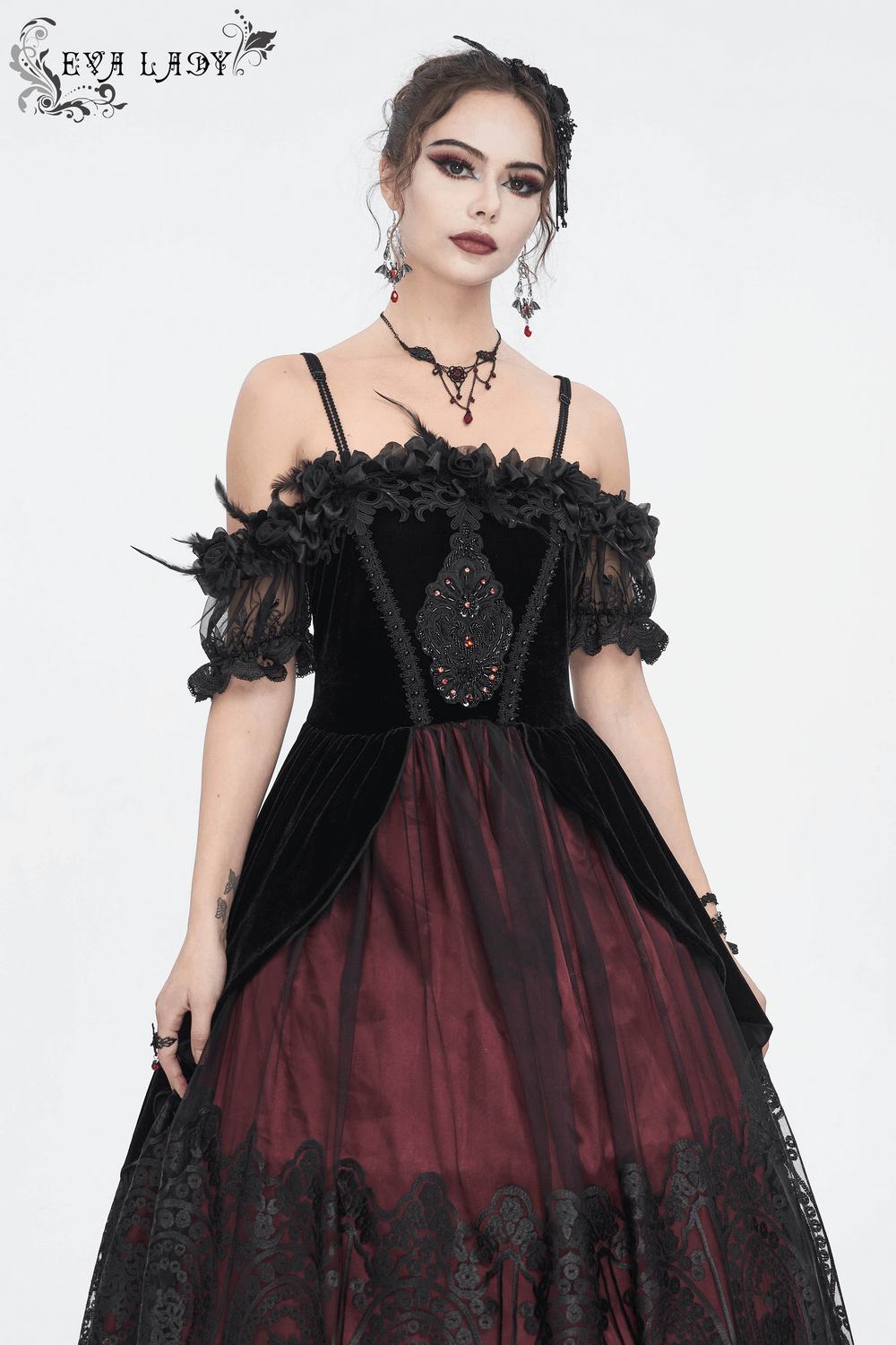 Elegant black and burgundy off-the-shoulder Victorian velvet dress with dramatic details.