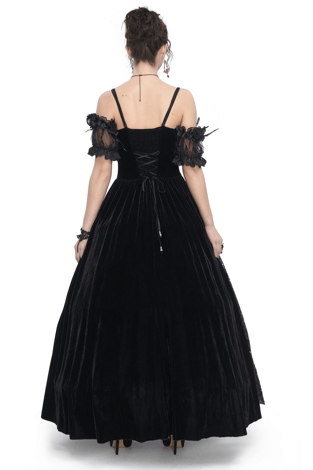 Back view of an elegant black velvet off-the-shoulder Victorian dress with lace accents and a flowing skirt.