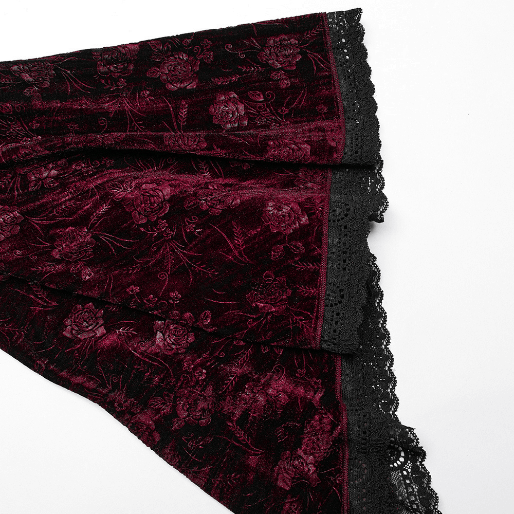 Elegant burgundy velvet fabric with intricate floral texture and black lace trim, perfect for a gothic dress.