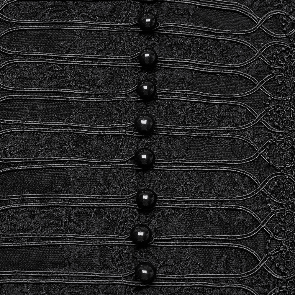 Close-up of elegant black lace corset blouse featuring intricate floral embroidery and glossy buttons.