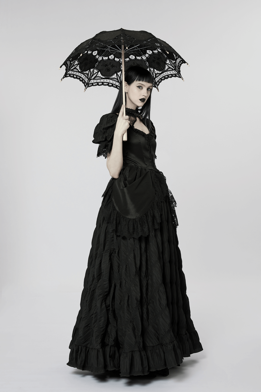 Elegant Victorian gothic lace evening gown with an intricate black umbrella, exuding dark elegance and allure.