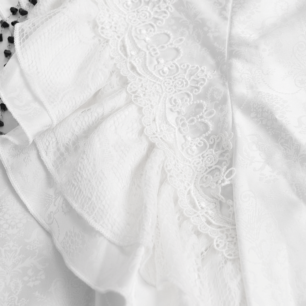 Close-up of elegant white fabric with intricate ruffles and lace, perfect for a Victorian gothic style shirt.