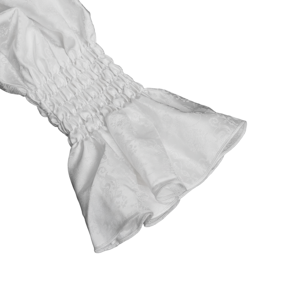 Elegant white ruffled cuff of a Victorian Gothic shirt, showcasing smocked detail and flared design for a romantic style.