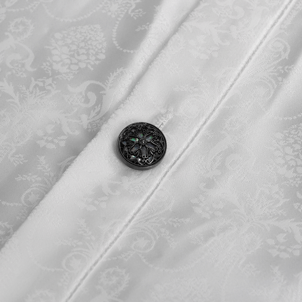 Close-up of elegant Victorian Gothic shirt button, highlighting intricate design on subtle white fabric.