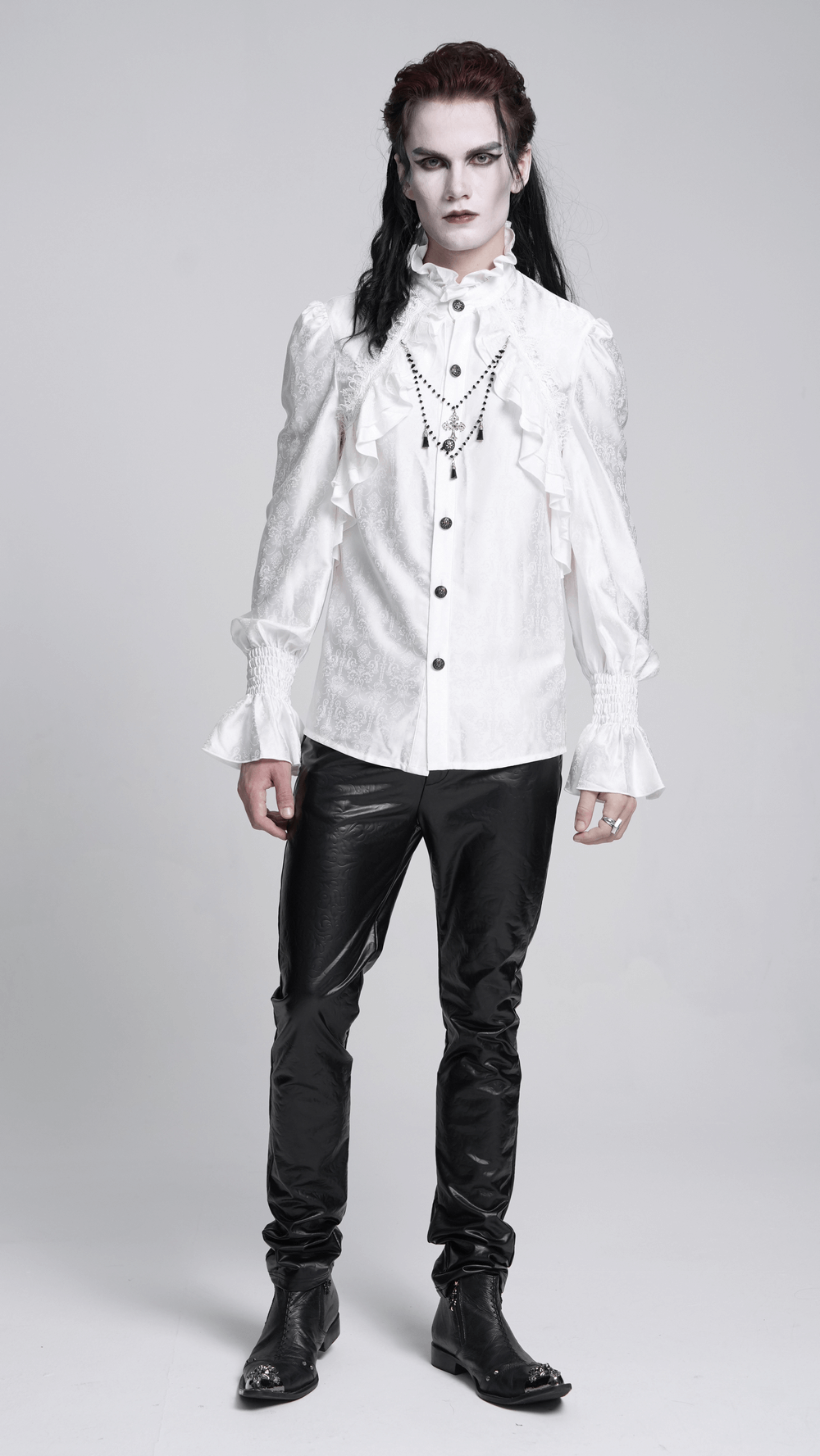 Elegant Victorian gothic man in ruffled long sleeve white shirt and black pants, showcasing a steampunk aesthetic.