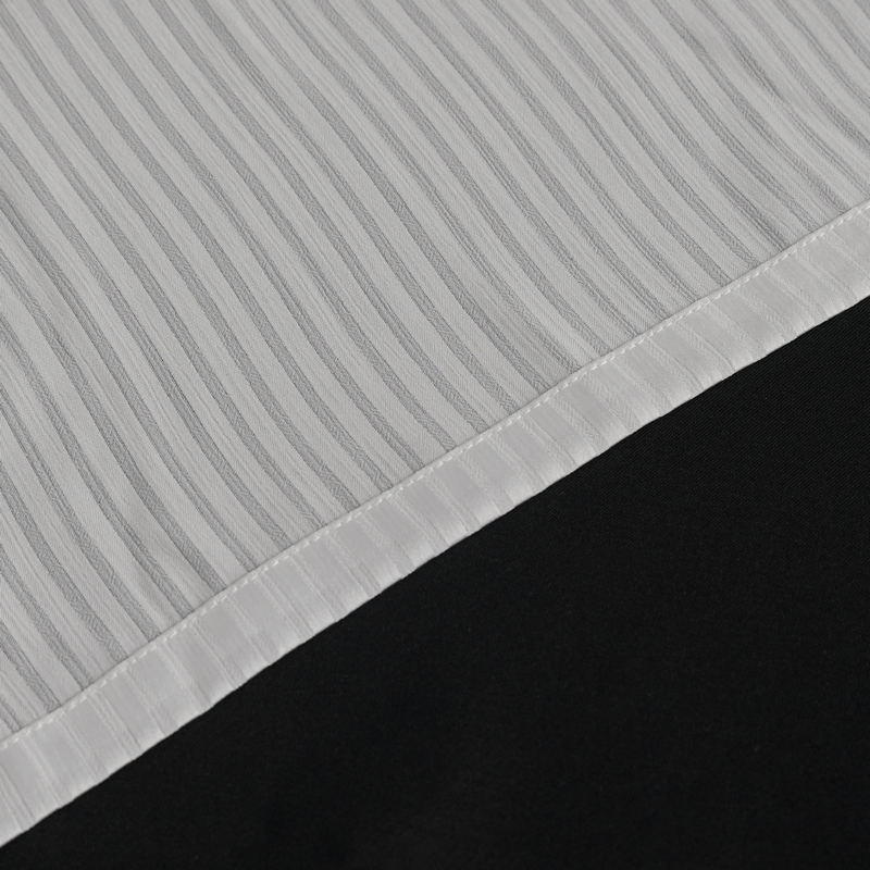 Close-up of pleated ruffle shirt showing elegant white ridged fabric and black detailing, perfect for Victorian-inspired style.