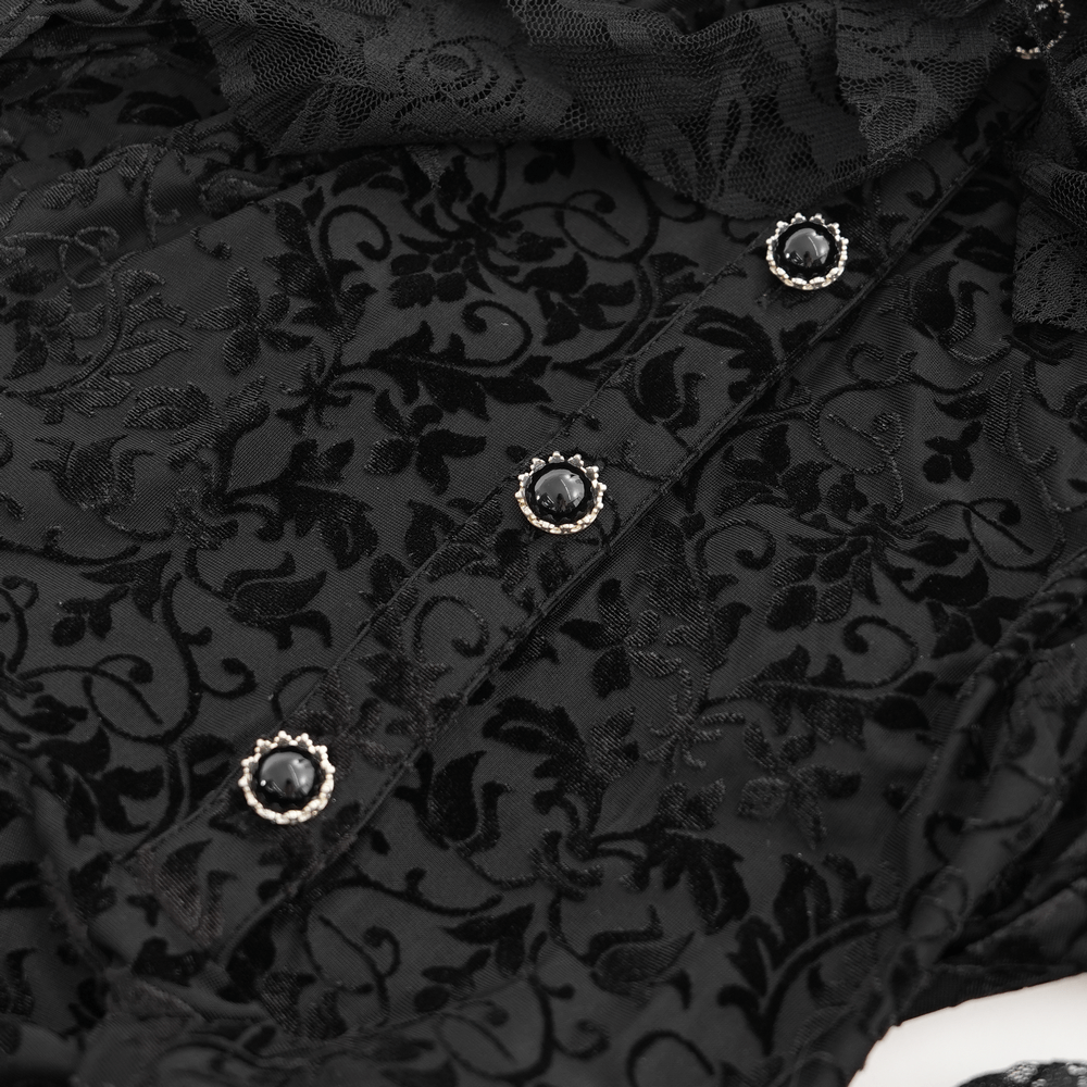 Close-up of intricate black lace dress with ornate button details and ruffles, showcasing gothic elegance.