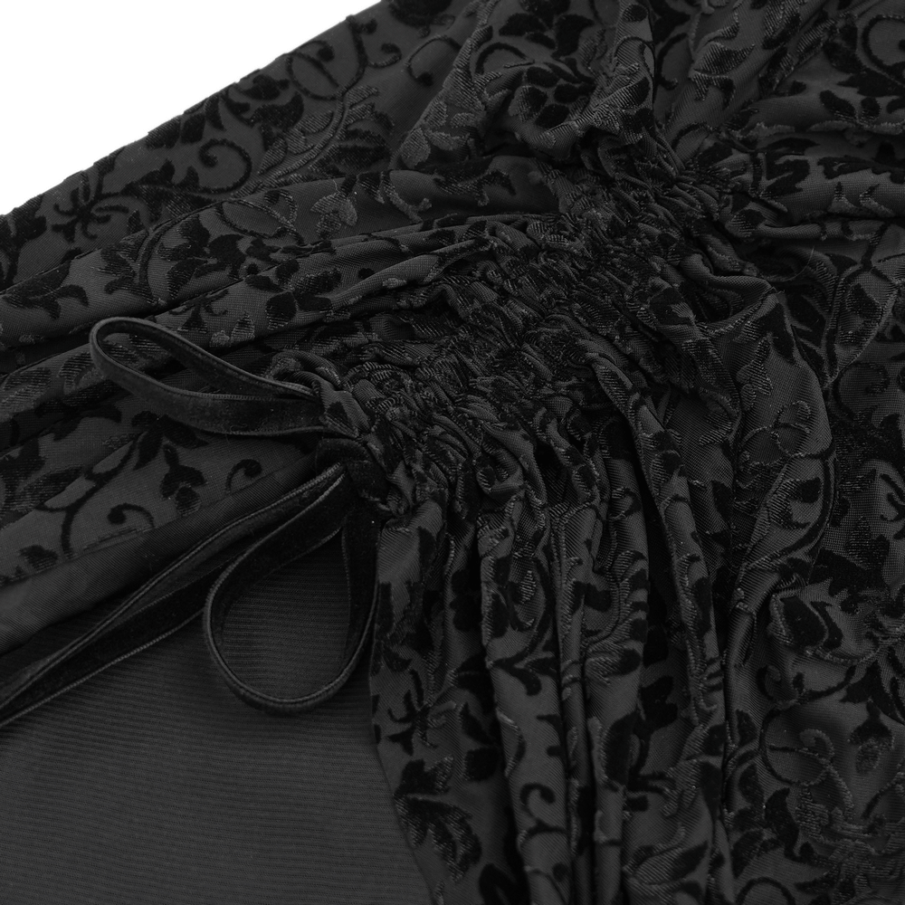 Close-up of elegant black lace fabric with intricate floral patterns and ruffled details for Gothic Victorian dress.