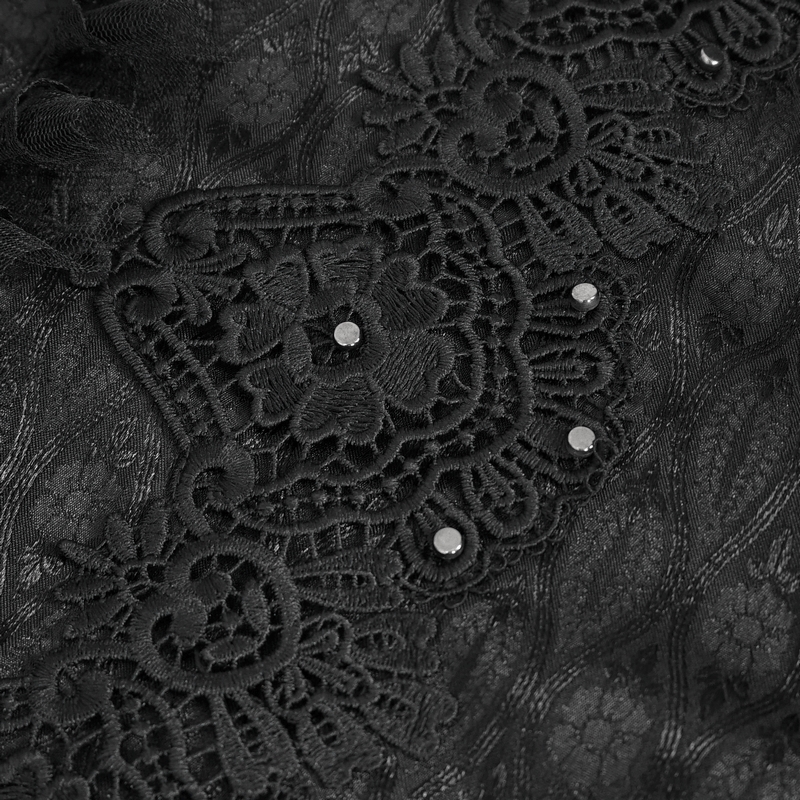 Close-up of intricate black lace trim with floral patterns and decorative gems, showcasing Victorian elegance.