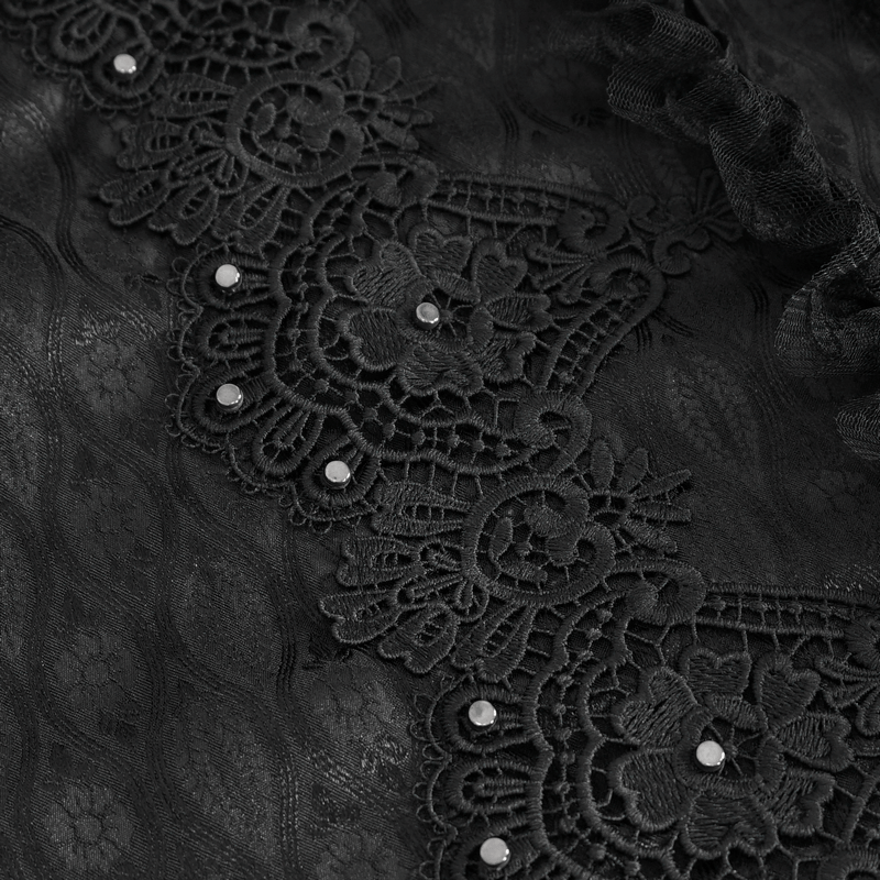Close-up of intricate black lace trim with embellishments on a Victorian-style shirt.