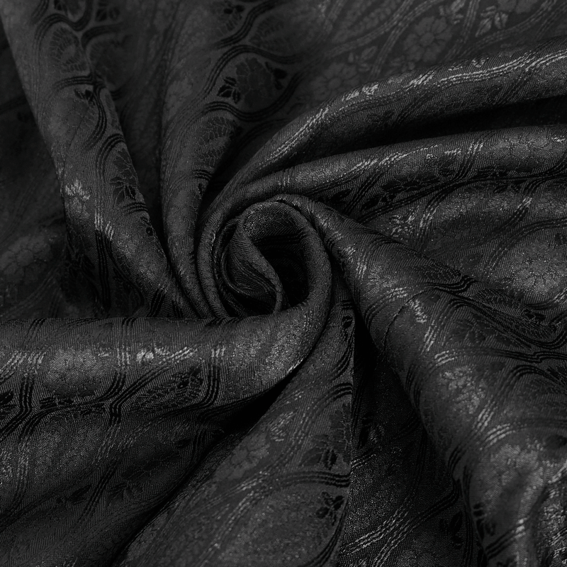Close-up of luxurious black fabric with intricate floral patterns, perfect for Victorian-inspired fashion.