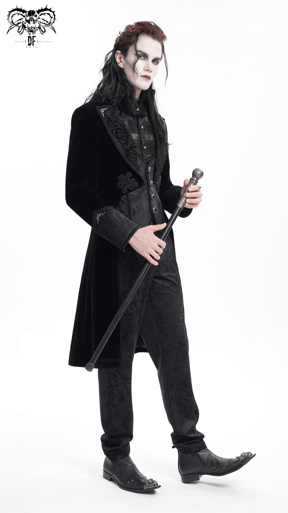 Gothic Victorian tailcoat with embroidered lapels, worn by a model holding a cane, showcasing timeless elegance.