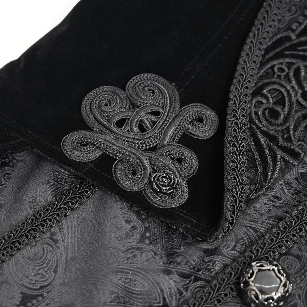 Close-up of intricate black embroidery on a Victorian tailcoat, showcasing ornate brocade details and a unique design.