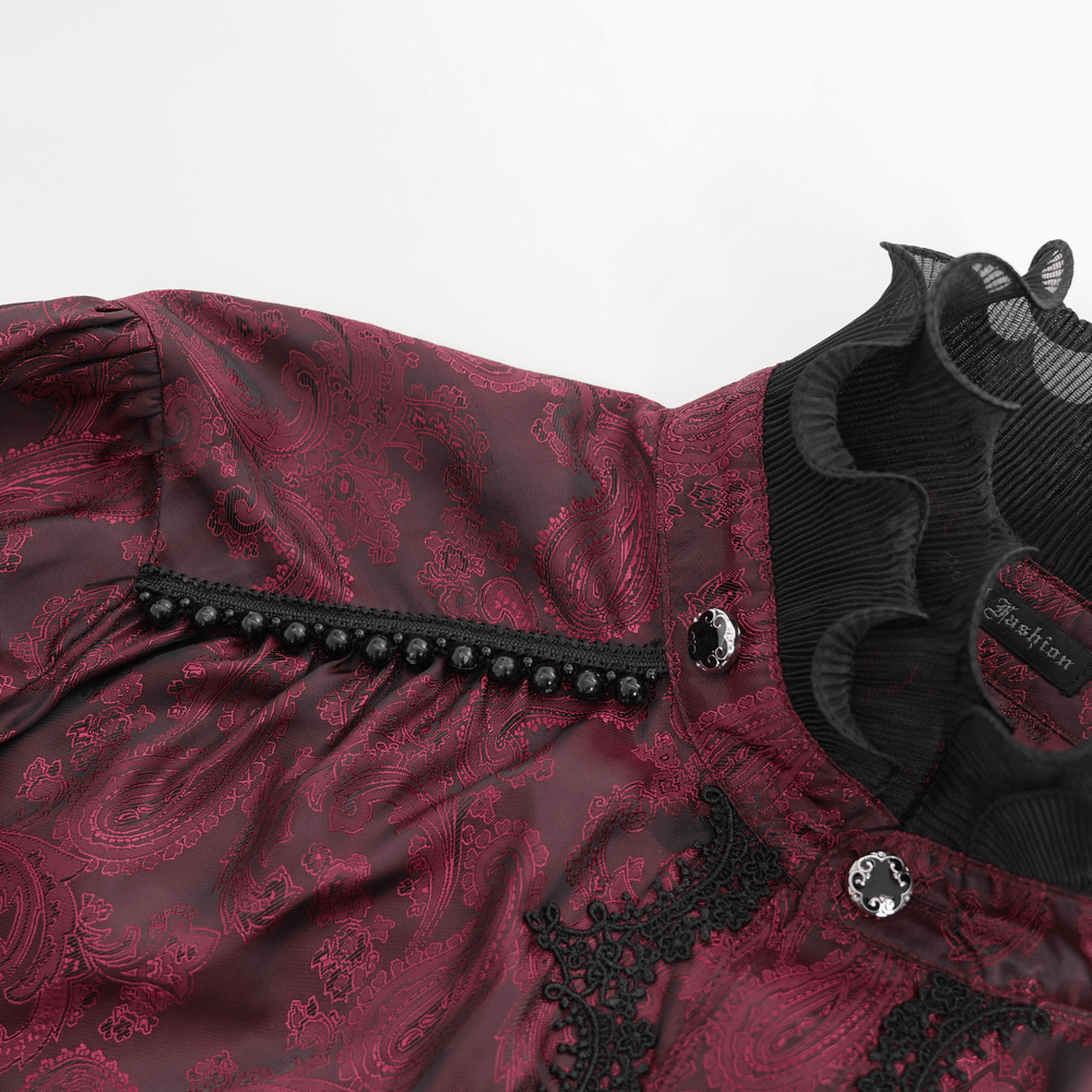 Detail view of elegant Victorian wine red shirt featuring ruffles, lace trim, and black buttons for a gothic aesthetic.