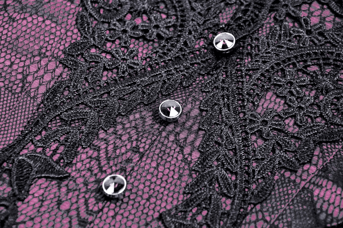 Close-up of intricate black lace with sparkling buttons on a rich purple background, perfect for vintage corset styles.