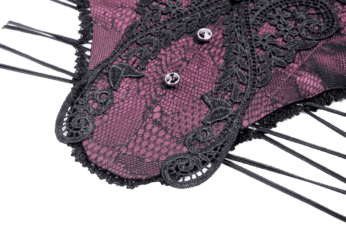Close-up of an elegant vintage lace-up corset belt with intricate black lace and rich purple hue.