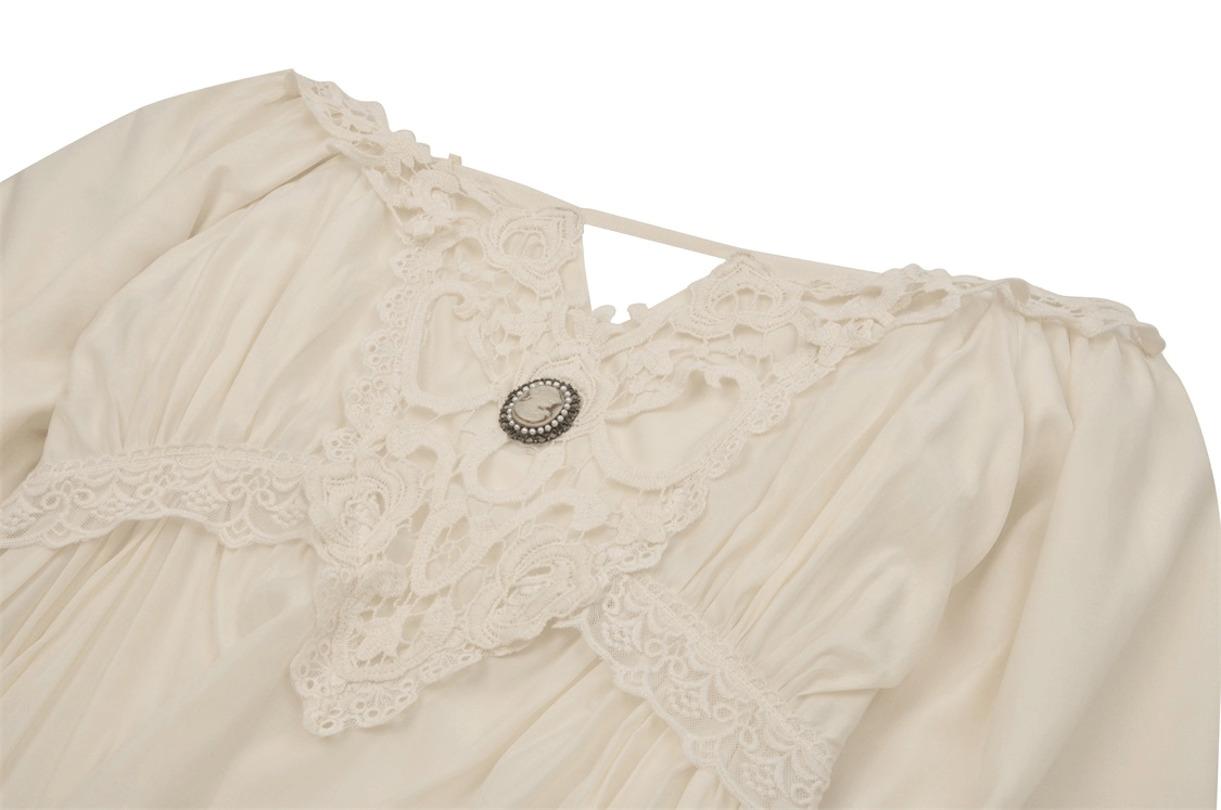 Elegant ivory vintage dress featuring intricate lace detail and a decorative button for a romantic touch.