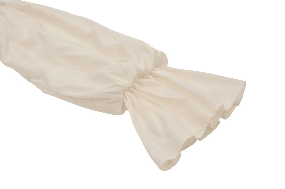 Elegant ivory long sleeve detail of a vintage maxi dress with delicate lace accents.