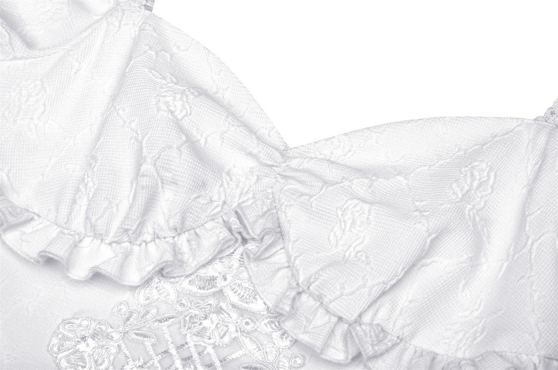 Close-up of elegant white dress with lace detail and ruffled neckline, showcasing floral embroidery perfect for bridal wear.