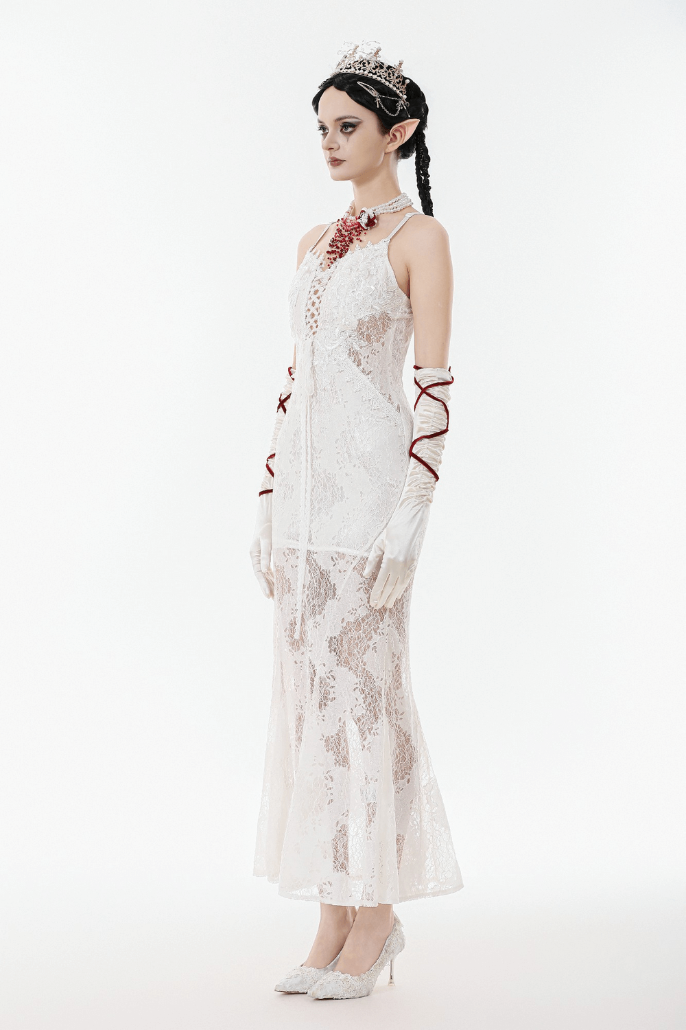 Elegant White Lace Gothic Dress with Spaghetti Straps modeled by a woman with gloves and accessories.