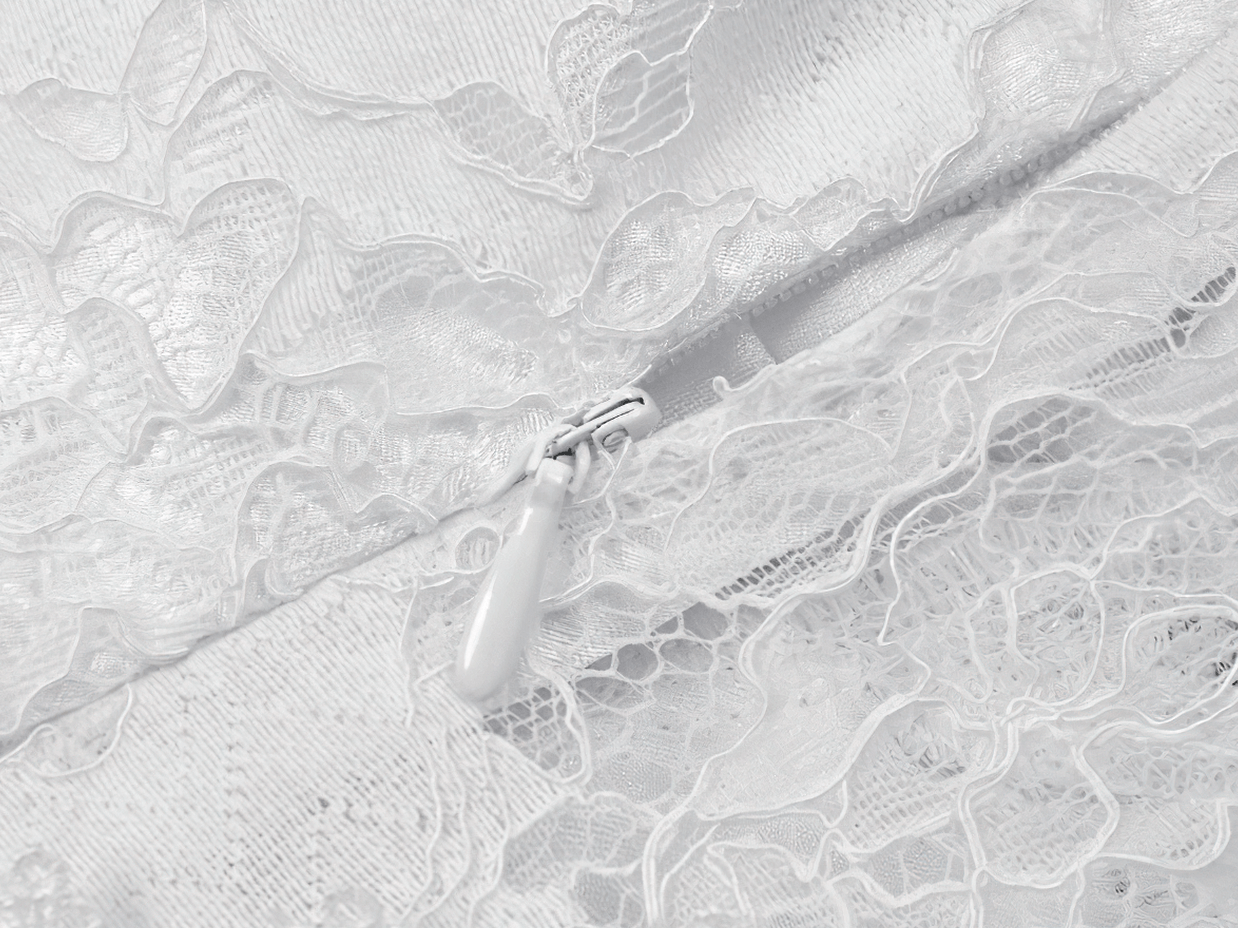 Elegant White Lace Gothic Dress with Spaghetti Straps close-up of delicate lace detailing and zipper.