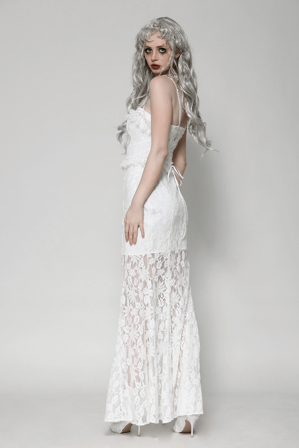 Elegant white lace mermaid dress with spaghetti straps, featuring ruffled details and a stunning flared skirt. Perfect for special occasions.