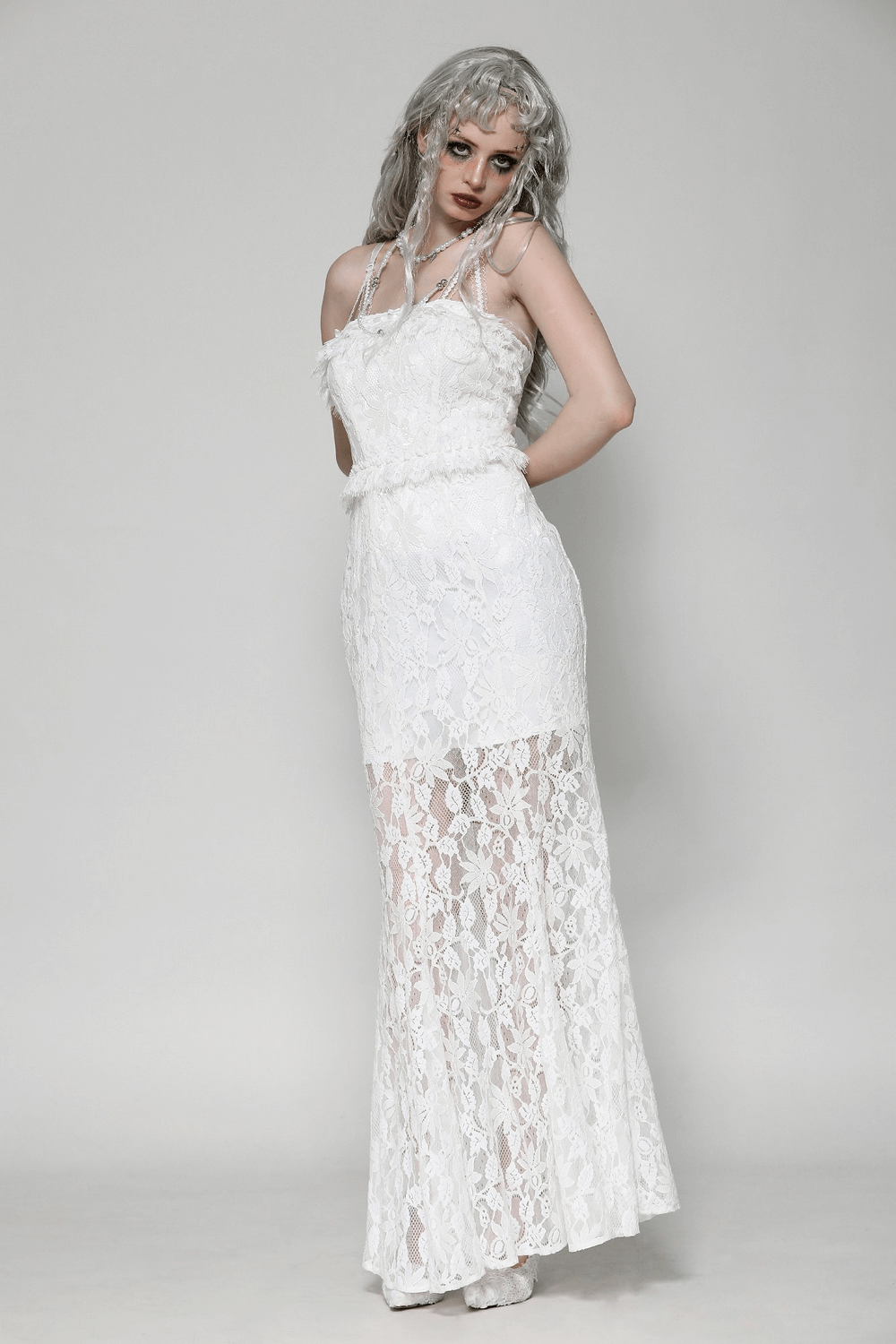 Elegant white lace mermaid dress with spaghetti straps and ruffled details, perfect for special occasions.