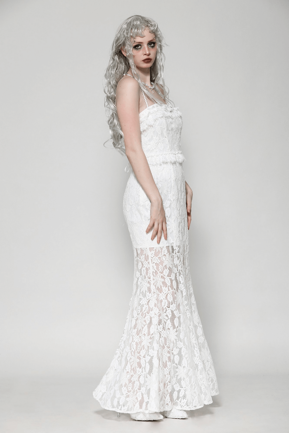 Elegant white lace mermaid dress with spaghetti straps and ruffled details, perfect for formal occasions and weddings.