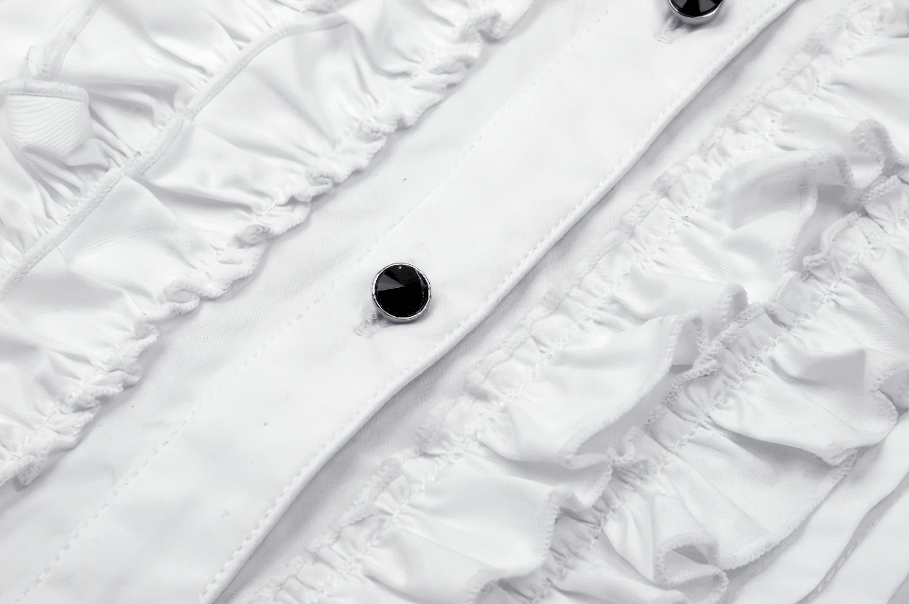 Close-up of an elegant white blouse with ruffle detailing and button accents, showcasing its sophisticated design.