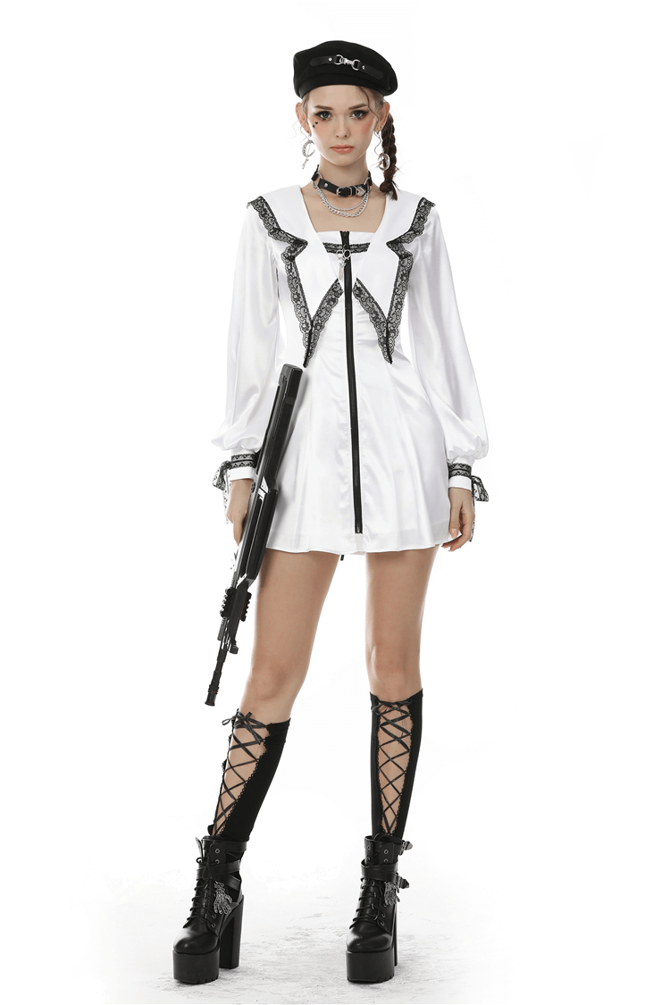 Chic white satin mini dress with black lace trim, styled with knee-high lace-up boots and accessories.