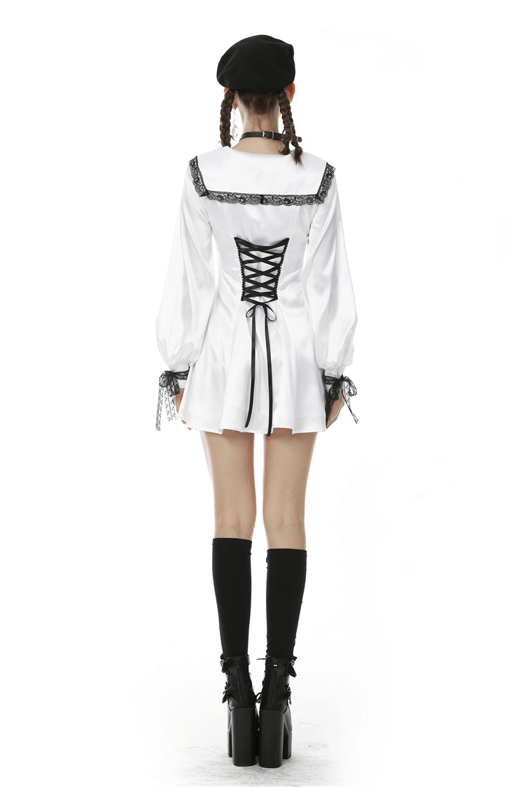 Back view of elegant white satin mini dress with black lace detailing and stylish pigtails.