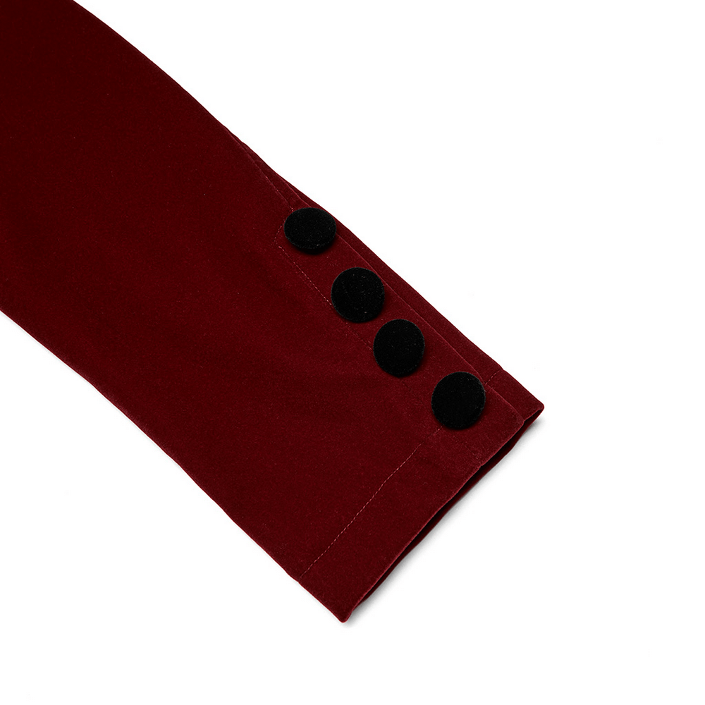 Close-up of wine red velvet jacket sleeve featuring decorative black buttons, highlighting gothic elegance.