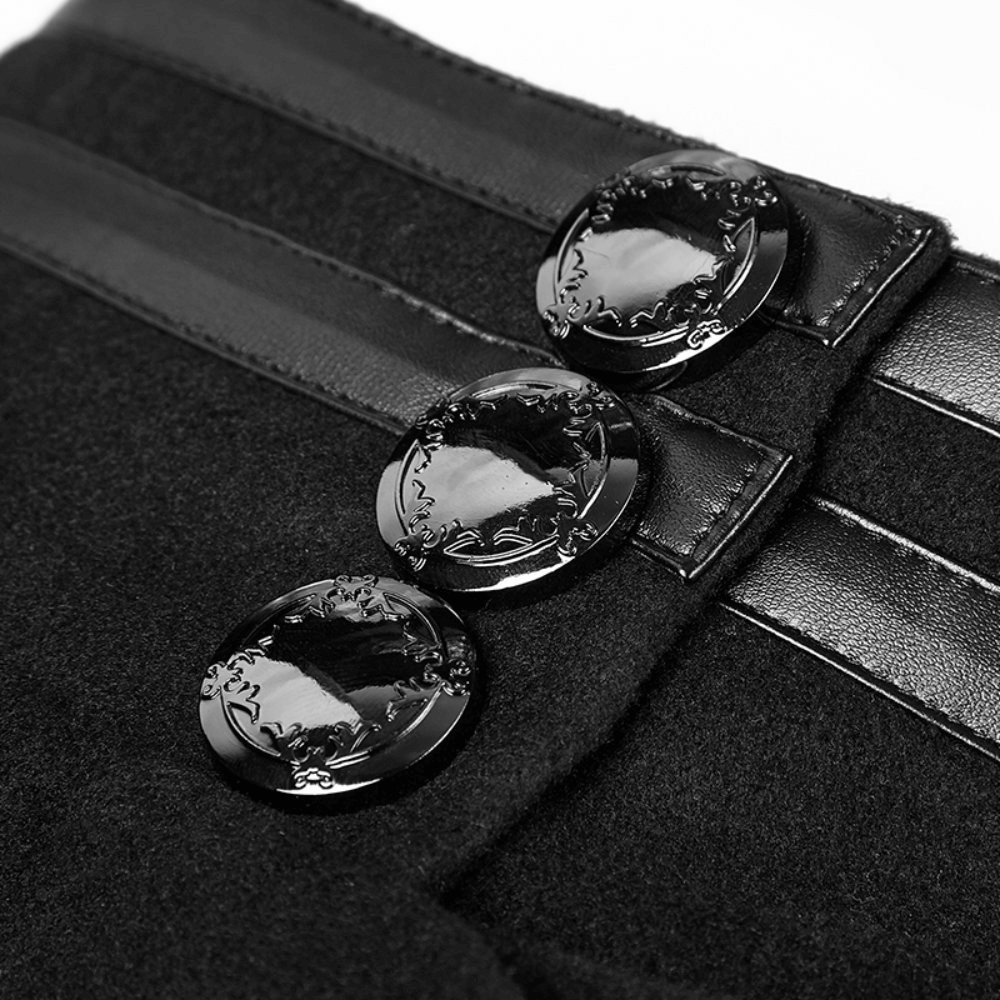 Close-up of exquisite black metal buttons on a stylish gothic coat with sleek ribbon detail.