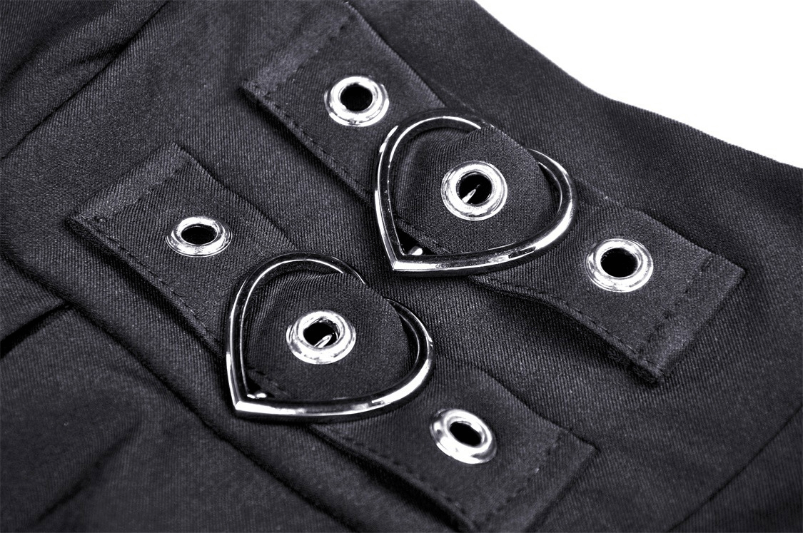 Close-up of unique heart-shaped belt detail on elegant black dress, adding a chic touch to evening wear.