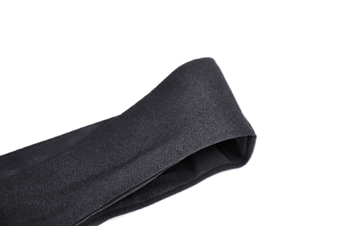 Close-up of a sleek black dress belt, showcasing its modern design and elegant texture for women's evening wear.