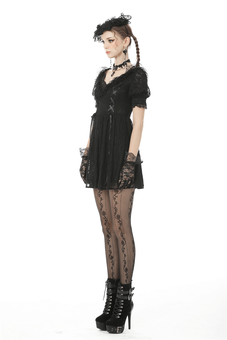 Elegant women's gothic black lace mini dress with puff sleeves and ribbon detail, paired with lace tights and platform heels.
