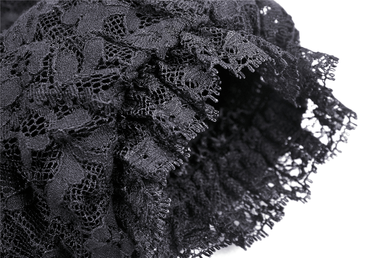 Close-up of elegant black lace featuring intricate patterns and delicate frills, perfect for vintage-style fashion.