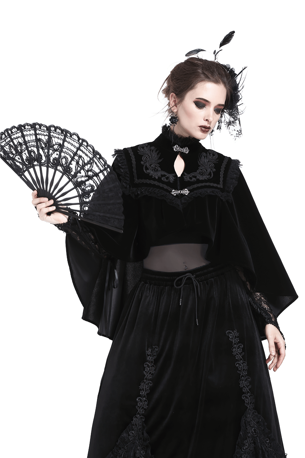 Elegant woman in gothic attire holding a black lace fan, perfect for evening events and stylish accessorizing.