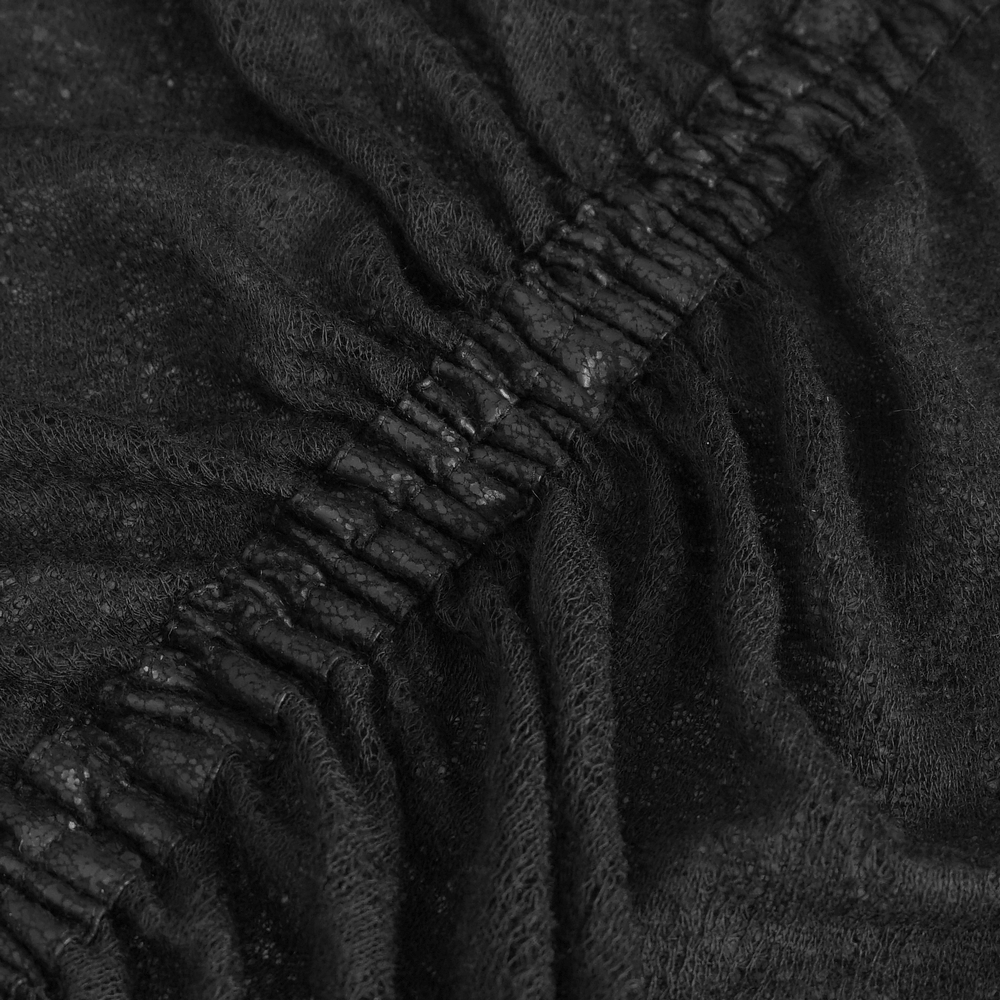 Close-up of elegant black sheer fabric with ruffle details, showcasing its texture and sophistication.