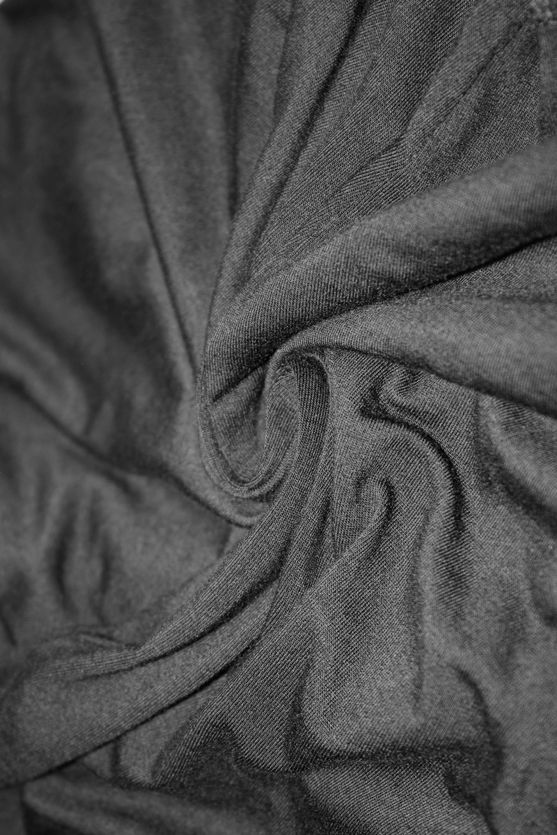 Close-up of luxurious black fabric showcasing a soft swirl texture, perfect for elegant gothic clothing.