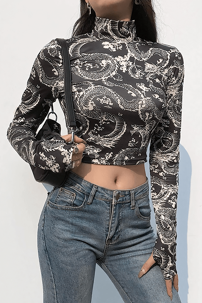 Elegant women's black crop top with floral print, perfect for gothic fashion, paired with high-waisted jeans.