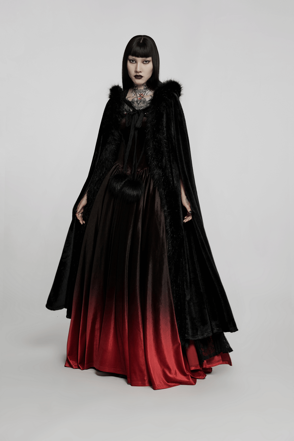 Elegant women's Gothic cloak with faux fur trim, featuring an opulent black and red design, perfect for a dramatic look.
