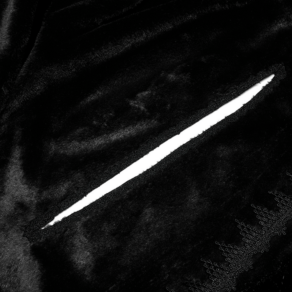 Close-up of elegant black velvet fabric with a hand opening in a Gothic faux fur cloak, showcasing luxurious details.
