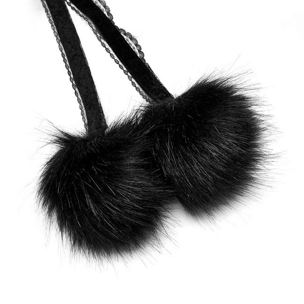 Close-up of black faux fur pom pom straps for an elegant Gothic cloak, showcasing detailed texture and design.