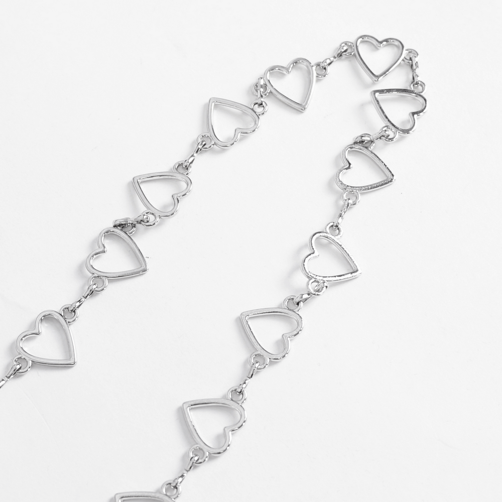 Stylish silver chain bracelet with heart-shaped links for a trendy accessory look.