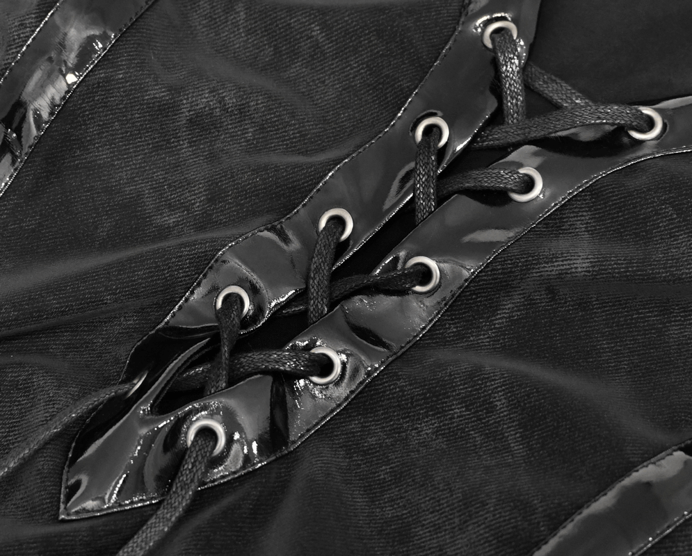 Close-up of elegant black dress detailing with leather straps and laces for gothic style fashion.