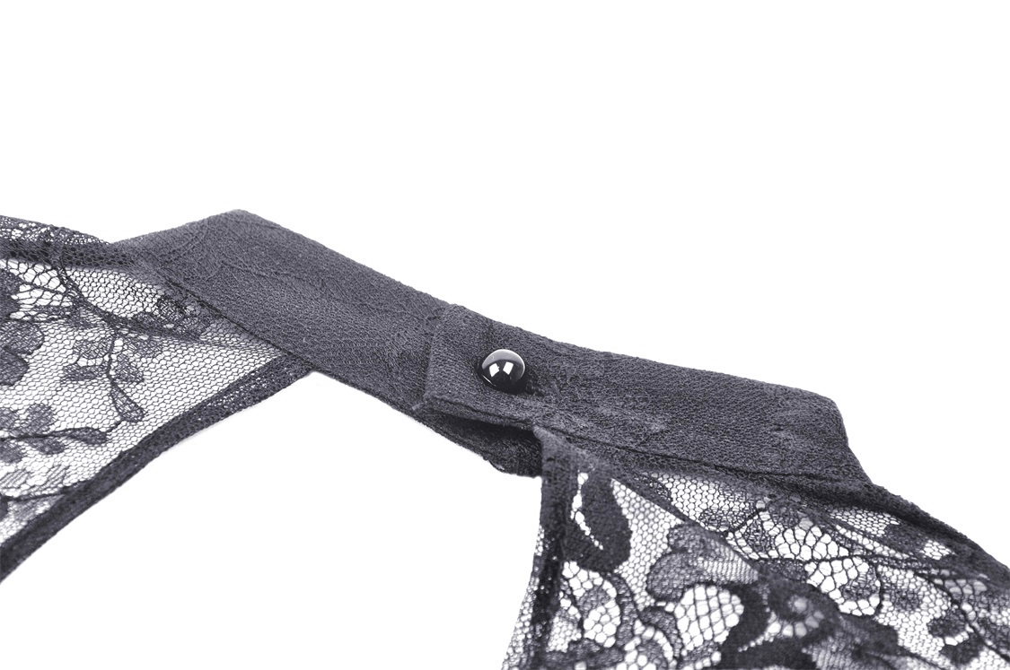 Close-up of the collar and button detail on an elegant black lace dress with floral embroidery.