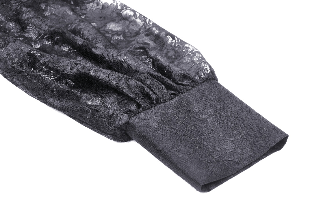 Close-up of black lace sleeve with intricate floral design, adding elegance to a chic dress.