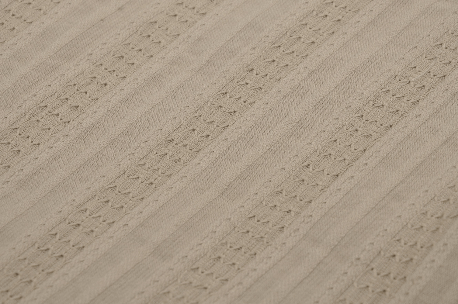 Close-up of elegant beige fabric with lace detail, perfect for layered women’s fashion skirts.