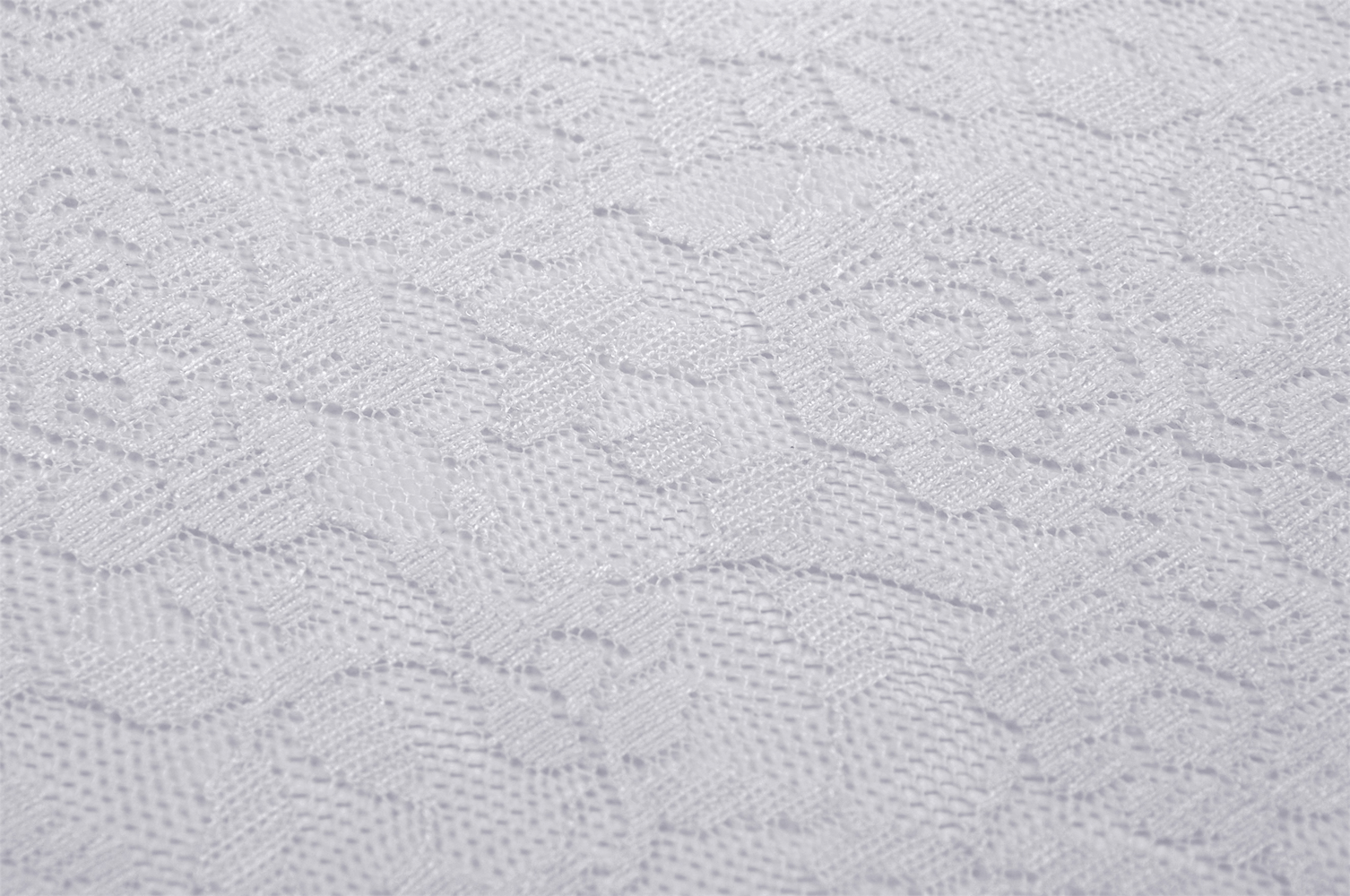 Close-up of delicate beige lace fabric with floral patterns for elegant fashion designs.
